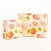 Close-up of illustrated fruit on gift box lid